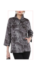 Woman wearing TERRA gray patterned statement jacket with high collar