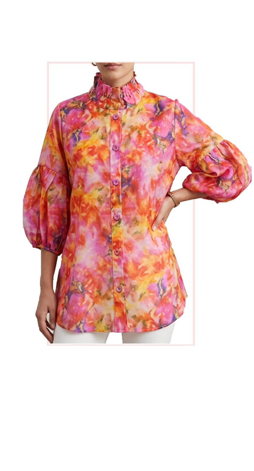 Woman wearing TERRA floral puff-sleeve button-down blouse in pink, orange and red, front view