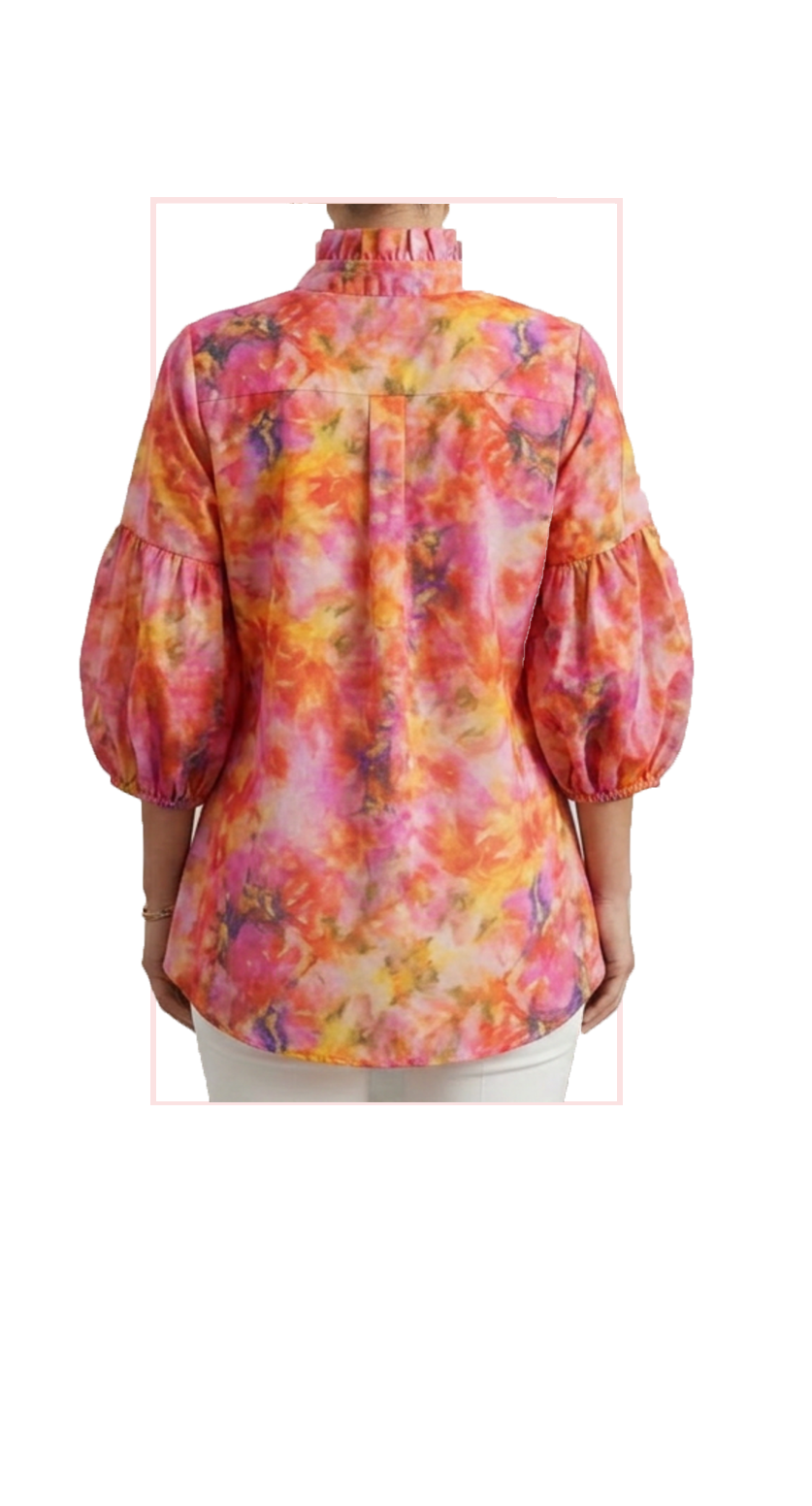 Woman wearing TERRA floral puff-sleeve button-down blouse in pink, orange and red, front view