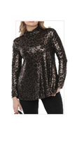 Woman wearing a TERRA leopard print long-sleeve top 