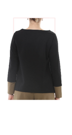 woman wearing a TERRA black and olive colored long-sleeve top with olive colored  pants rearview