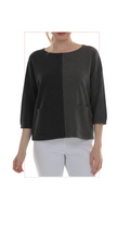 Woman wearing TERRA black and gray oversized color-block top, front view