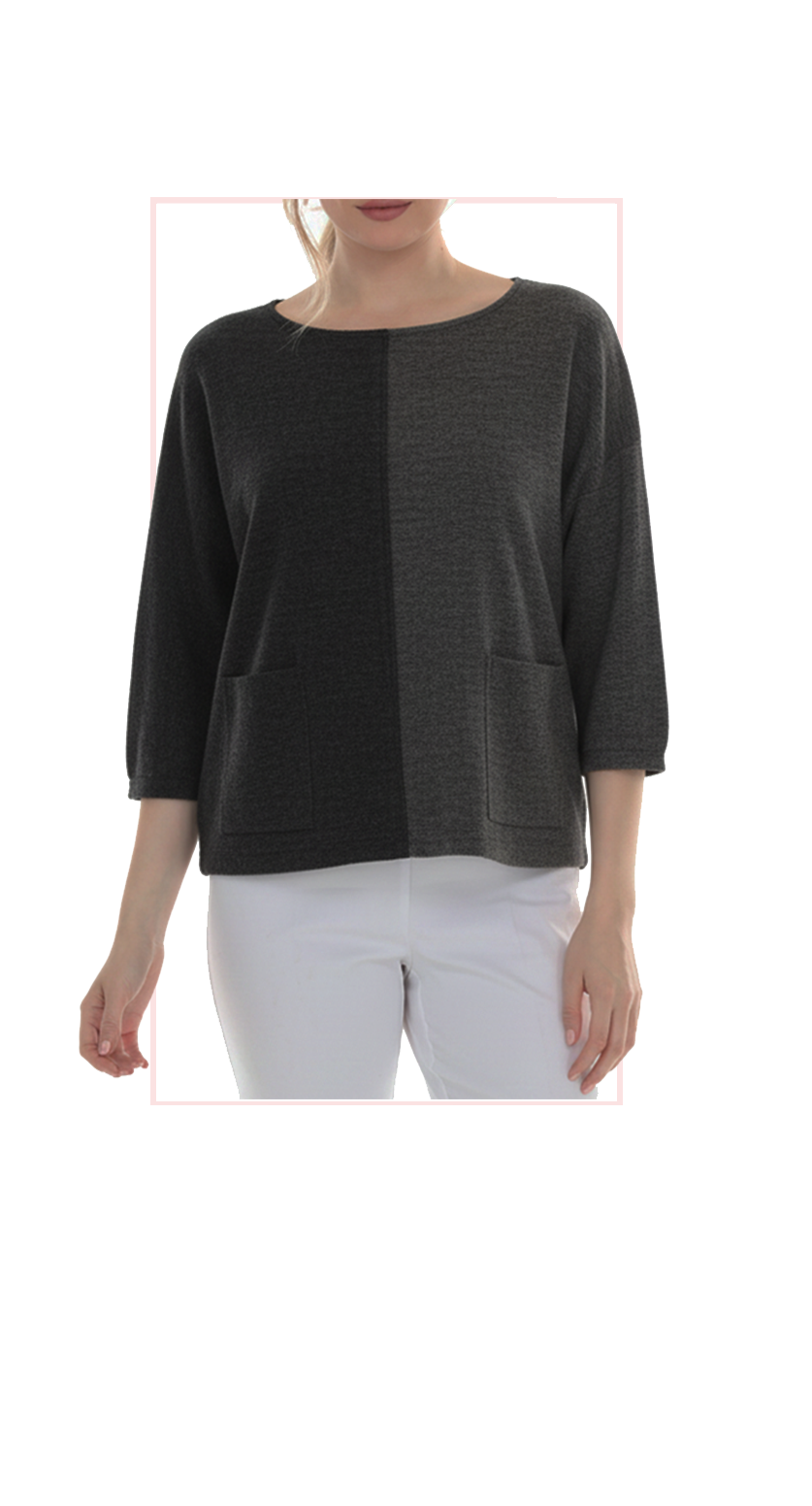 Woman wearing TERRA black and gray oversized color-block top, front view