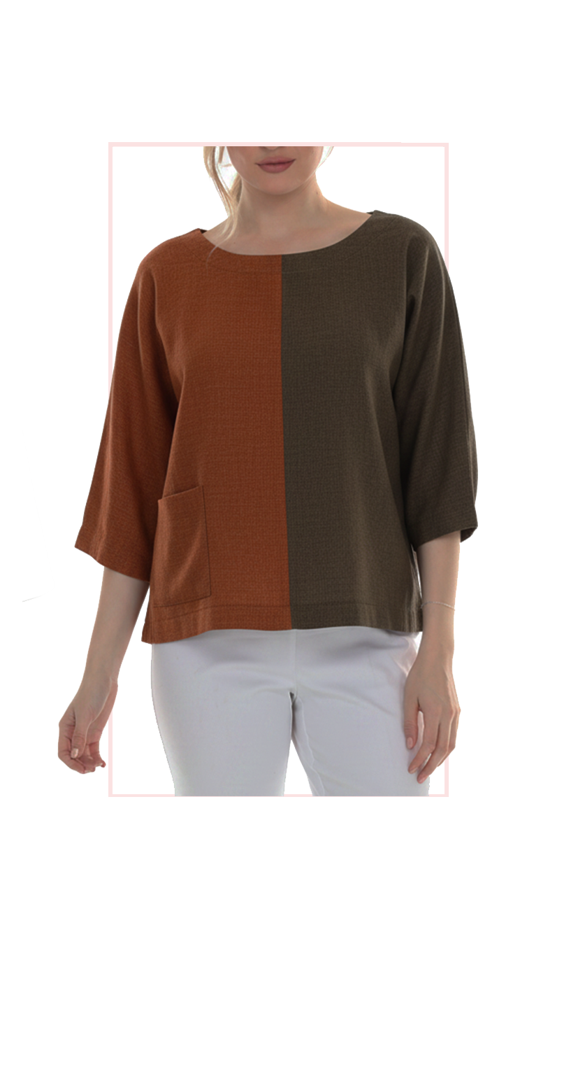 Woman wearing TERRA rust and brown oversized color-block top, front view