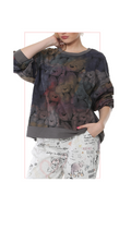 woman wearing a colorful Terra teddy bear graphic longsleeve sweater