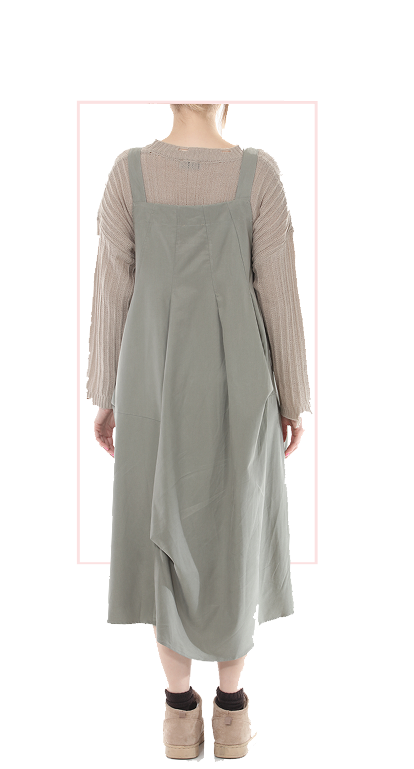 Woman wearing TERRA beige pinafore jumper dress, rear view