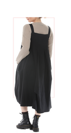 Woman wearing TERRA black pinafore jumper dress, rear view