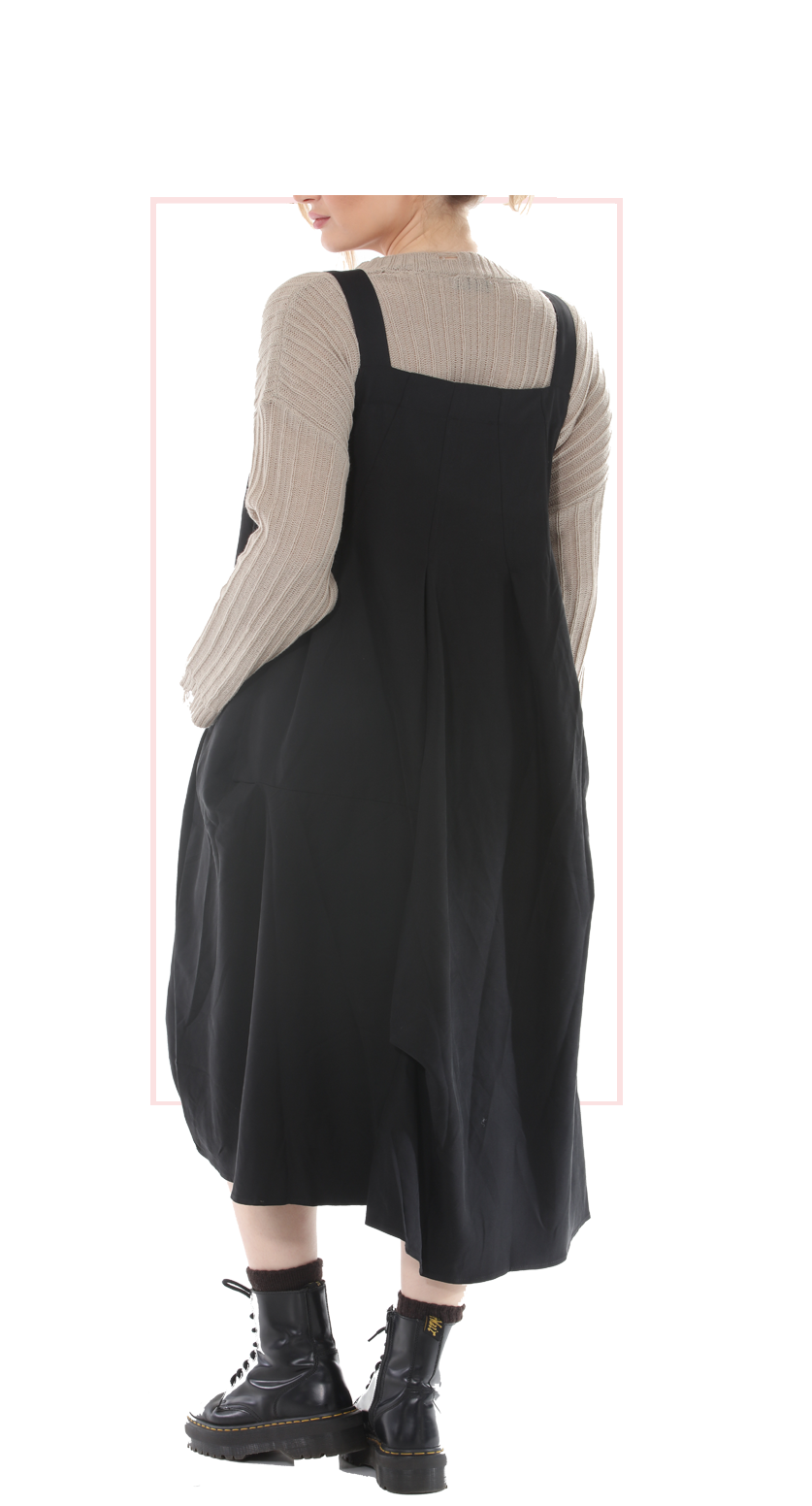 Woman wearing TERRA black pinafore jumper dress, rear view