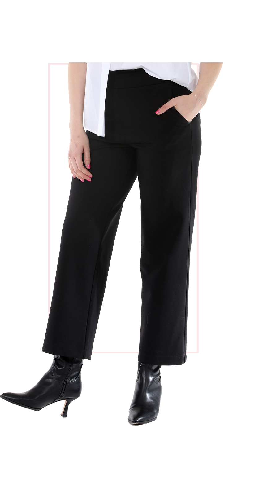 Woman wearing TERRA black high-rise wide-leg trousers with a flowing silhouette