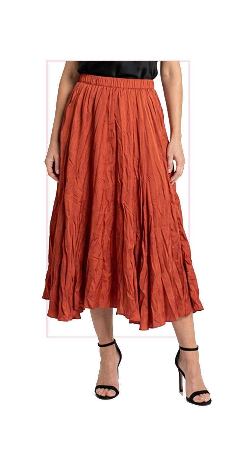 Woman wearing TERRA orange pleated midi skirt, front view