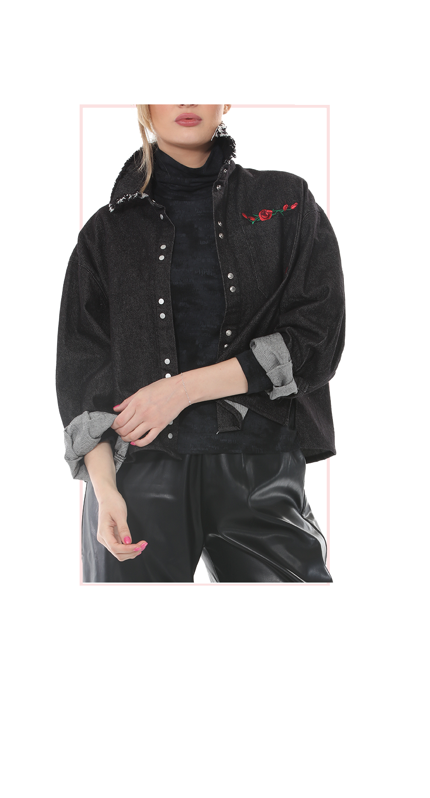 Woman wearing TERRA black denim embroidered jacket with snap buttons and raw-edge collar