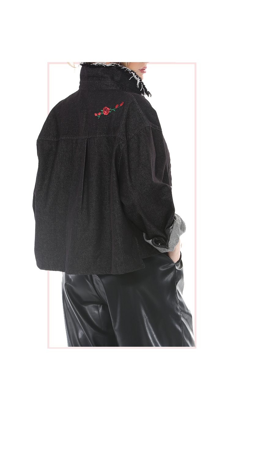 Woman wearing TERRA black denim embroidered jacket with snap buttons and raw-edge collar