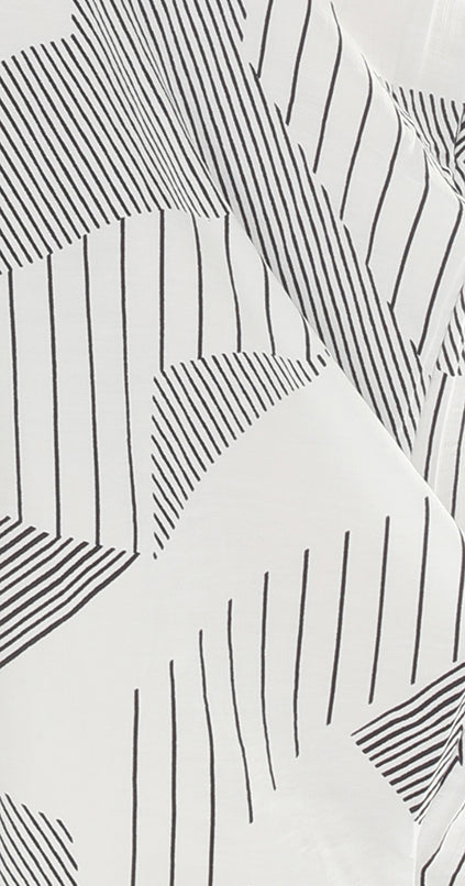 Close-up of a patterned fabric with black lines on a white background