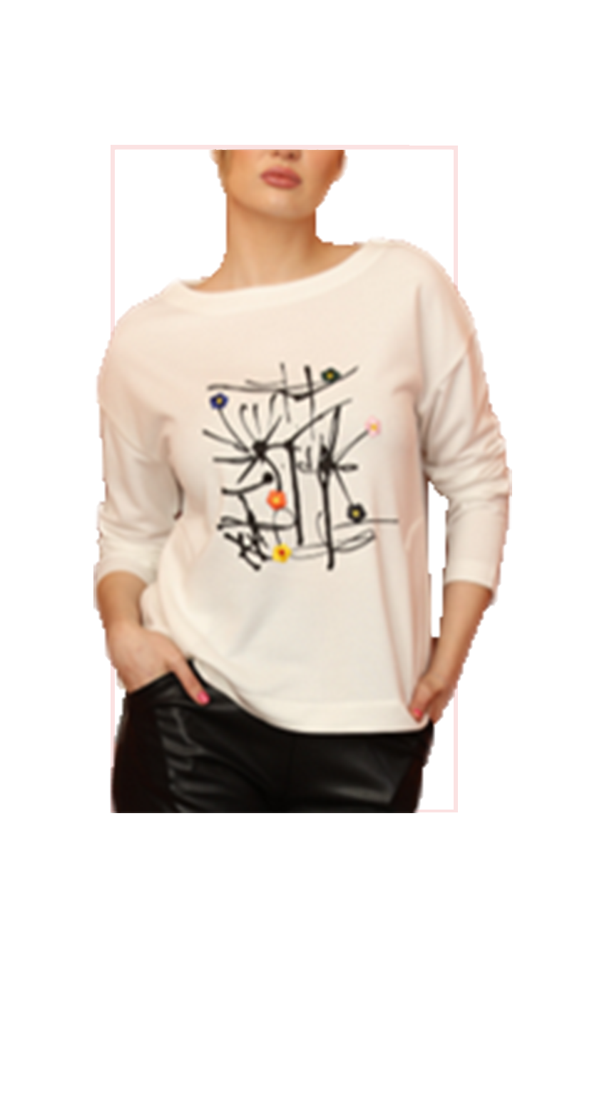 Person wearing a ivory colored sweater with black abstract design on a white background