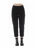 Black pants worn by a person on a white background