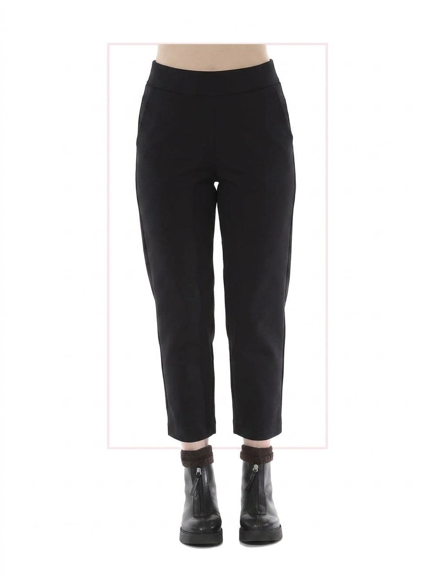 Black pants worn by a person on a white background
