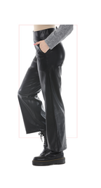 woman wearing black leather pants and black boots on a white background