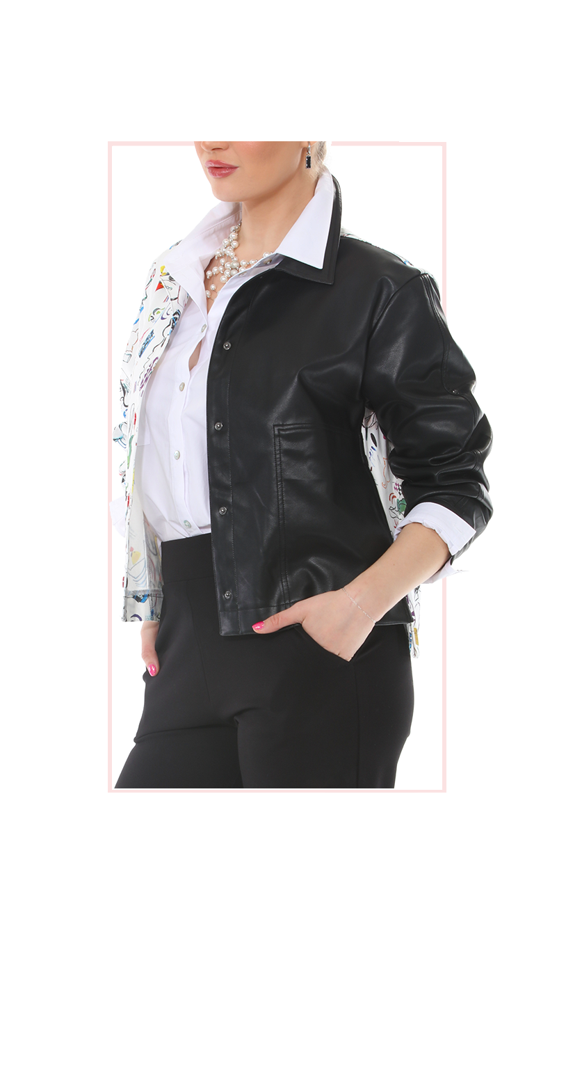woman wearing a black leather jacket with one patterned sleeve over a white shirt 