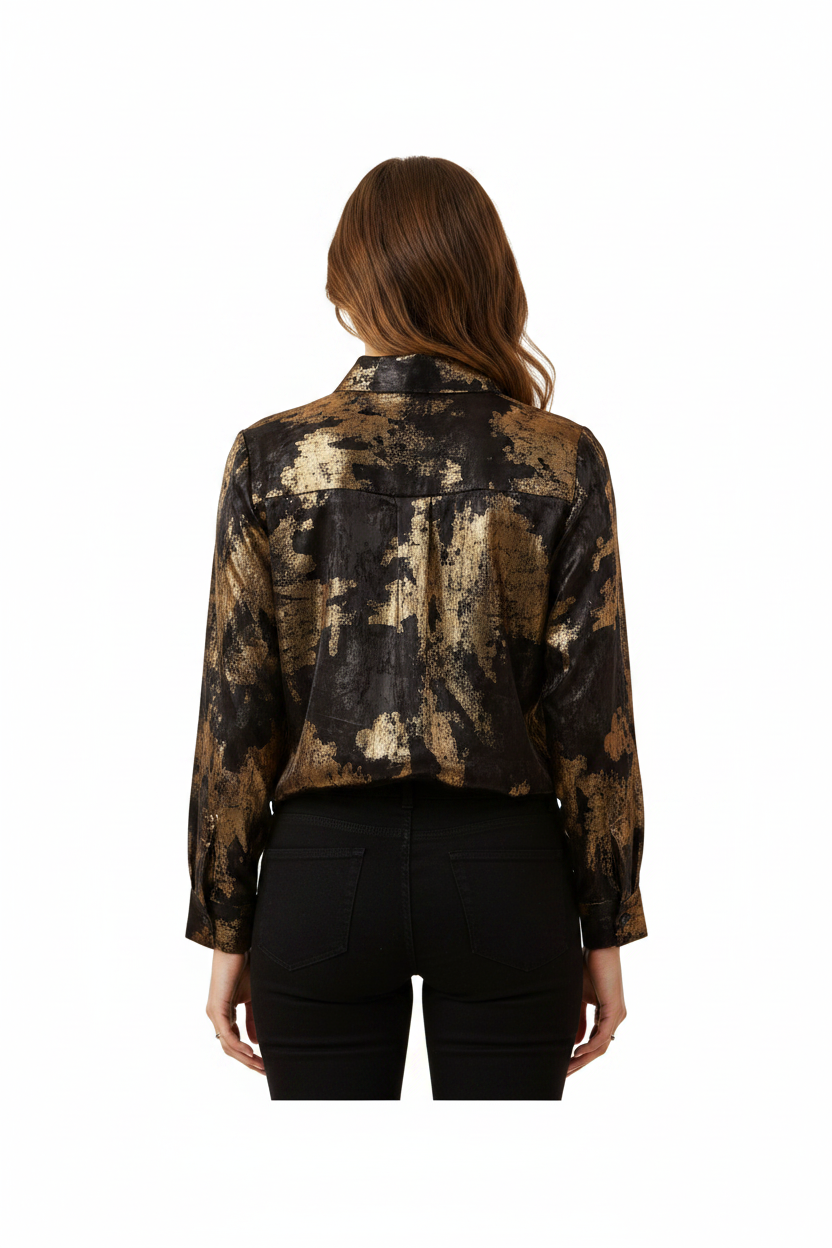 Woman wearing a black and gold patterned blouse on a white background